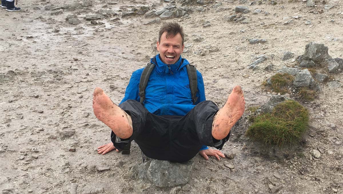 Henk barefoot on a rocky mountain path