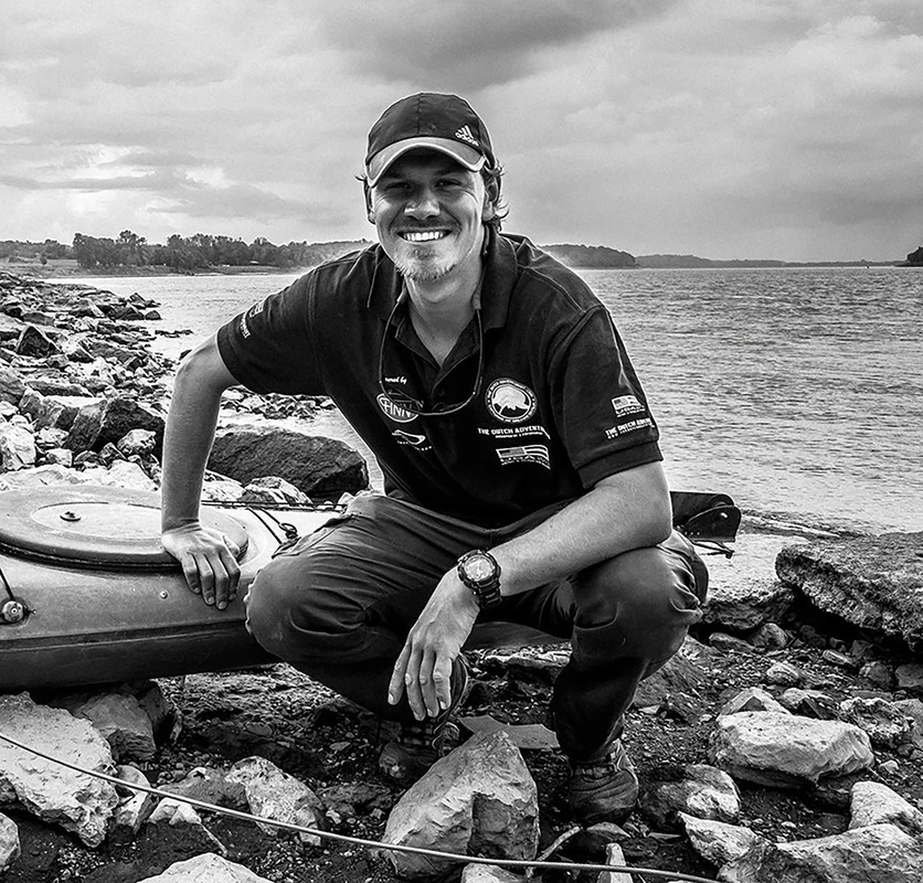 Henk beside his kayak on the banks of the Mississippi